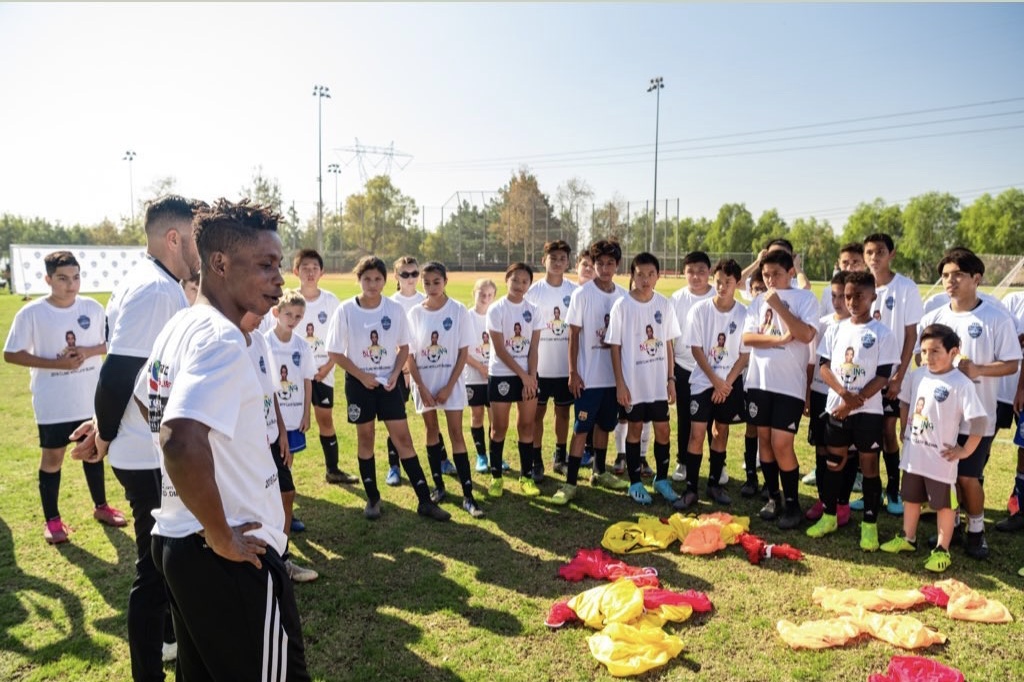 Coaches and players gather on the field