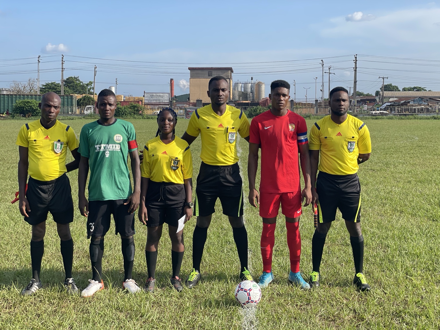 Match officials standing together on the football field